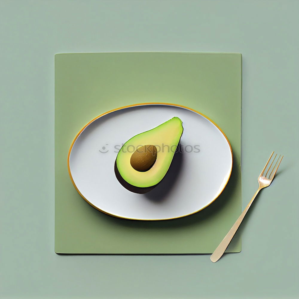 Similar – Cut avocado on white plate on pastel background