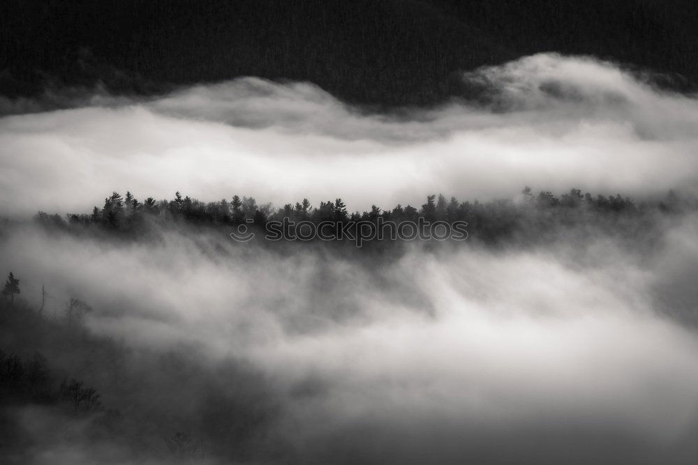 Similar – Mountain village in clouds of fog and smoke. Autumn morning.