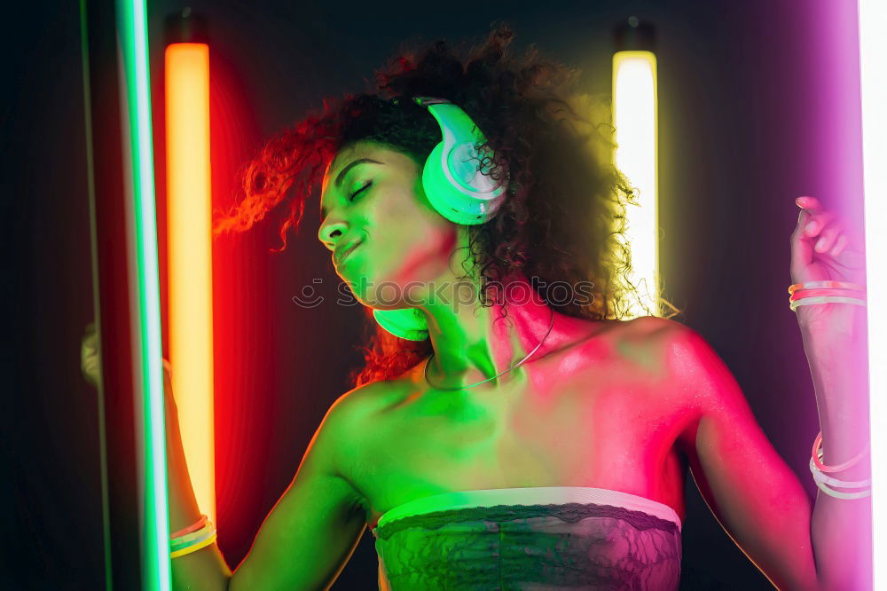 Similar – Young woman at night party with neon lights