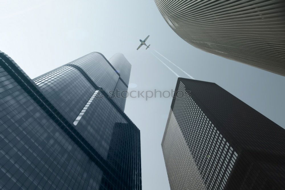 Similar – Plane flying over building