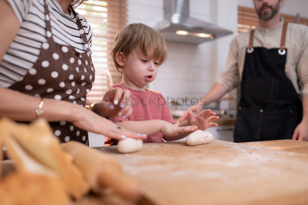 Similar – Image, Stock Photo Little sisters cooking with her mother in the kitchen.