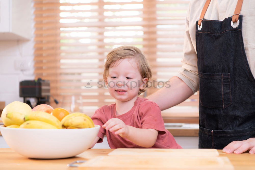 Similar – Woman feeding her little girl in kitchen