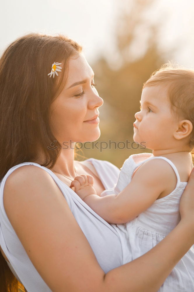 Similar – Image, Stock Photo Mother holding kid on hands in park