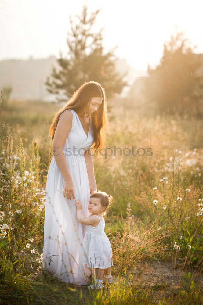 Similar – Mother holding walking child