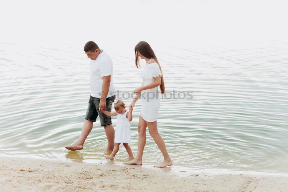 Similar – Happy family walking on the beach at the day time.