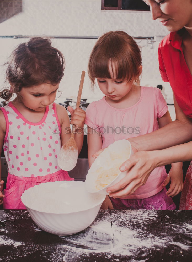 Similar – Image, Stock Photo Little sisters cooking with her mother in the kitchen.