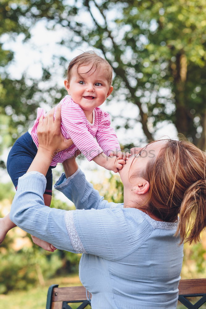 Similar – Mom reading a book her little daughter