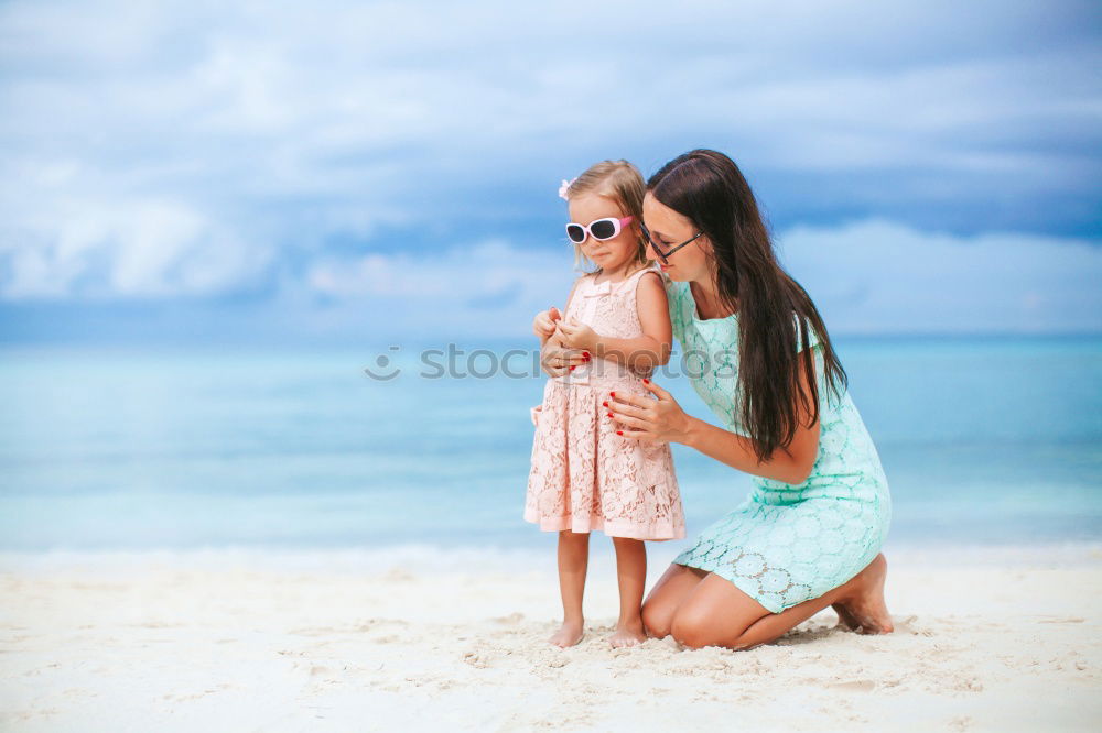 Similar – Mother and children playing on the beach at the day time. Concept of friendly family.