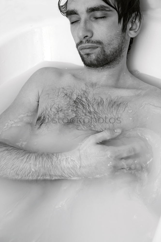 Similar – Young bearded man washing his hair