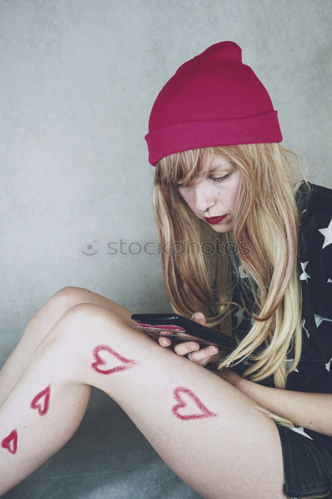 Young woman with hearts painted in her legs