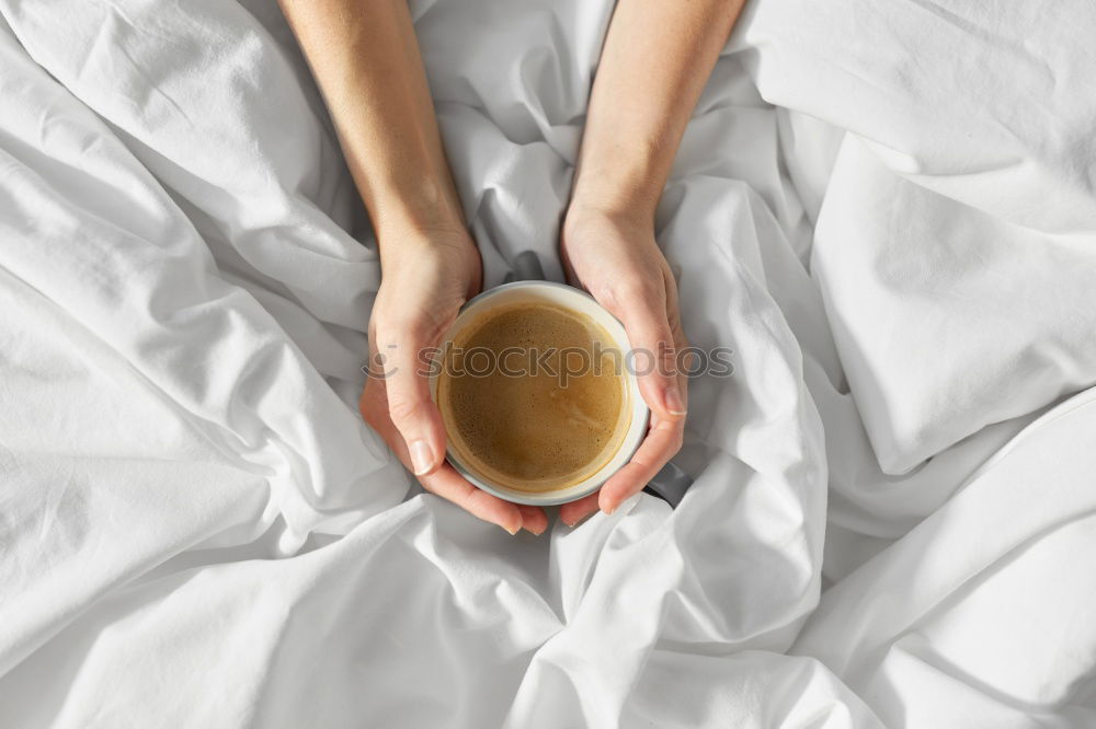 Image, Stock Photo Cup of coffee and spoon on wooden tray in bed on white sheets