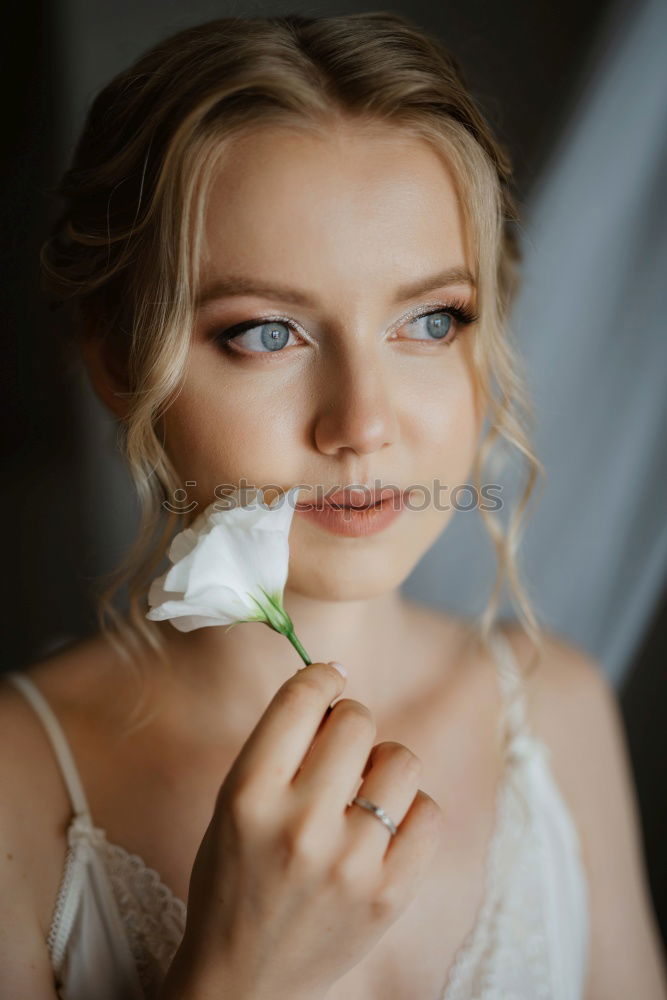 Similar – Pretty woman standing with white flowers