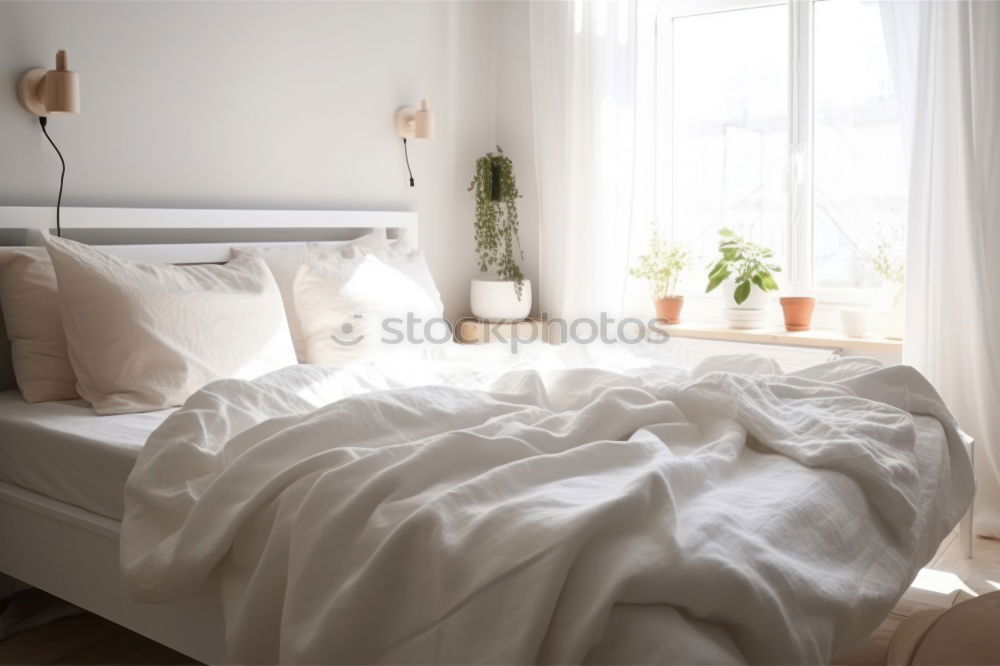 Similar – Ein Doppelbett mit weißer Bettwäsche und beigen Kissen in einem hellen skandinavischen Schlafzimmer, ein Bett auf dem Boden und Blumen in einer Vase