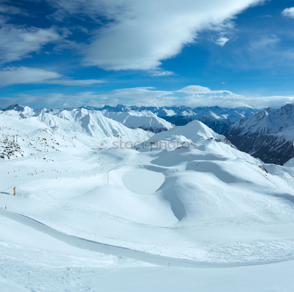 Similar – Image, Stock Photo Snowboarder goes downhill over a snowy mountain landscape