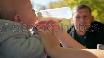 Similar – Image, Stock Photo Mother feeding newborn with baby bottle