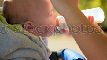 Similar – Image, Stock Photo Baby sucks on a bottle.