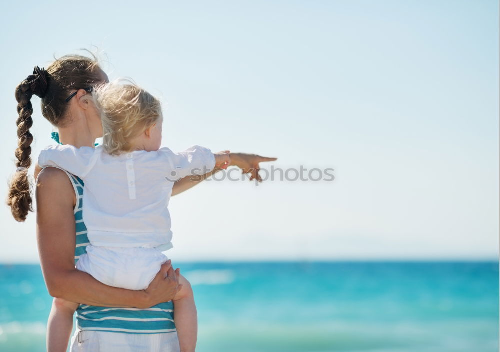 Similar – Image, Stock Photo Mother and son playing on the beach at the day time.