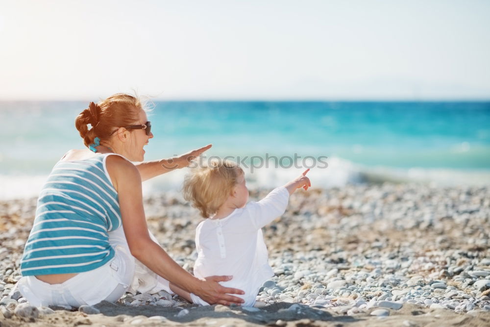 Similar – mother and son having fun with inflatable ring at beach