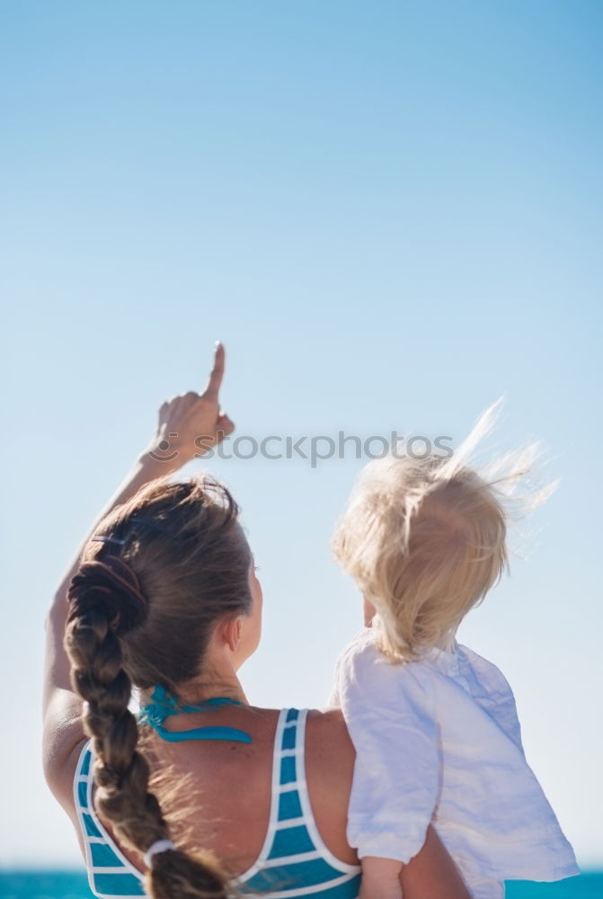 Similar – Father and daughter with balloons playing on the beach