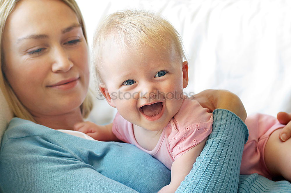 Similar – happy young mother and her baby boy lying on bed and smiling