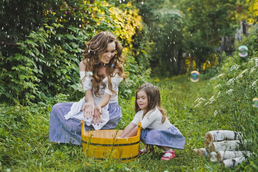 Similar – happy family: young mother walks with her child in the Park