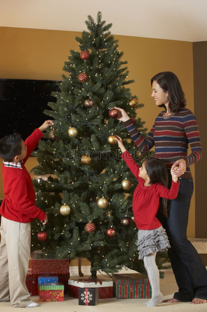 Similar – Young girl and her little sister decorating Christmas tree