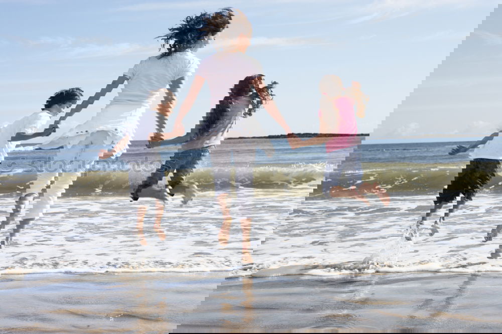 Similar – Image, Stock Photo Three happy children playing on the beach at the day time. Concept of summer vacation.