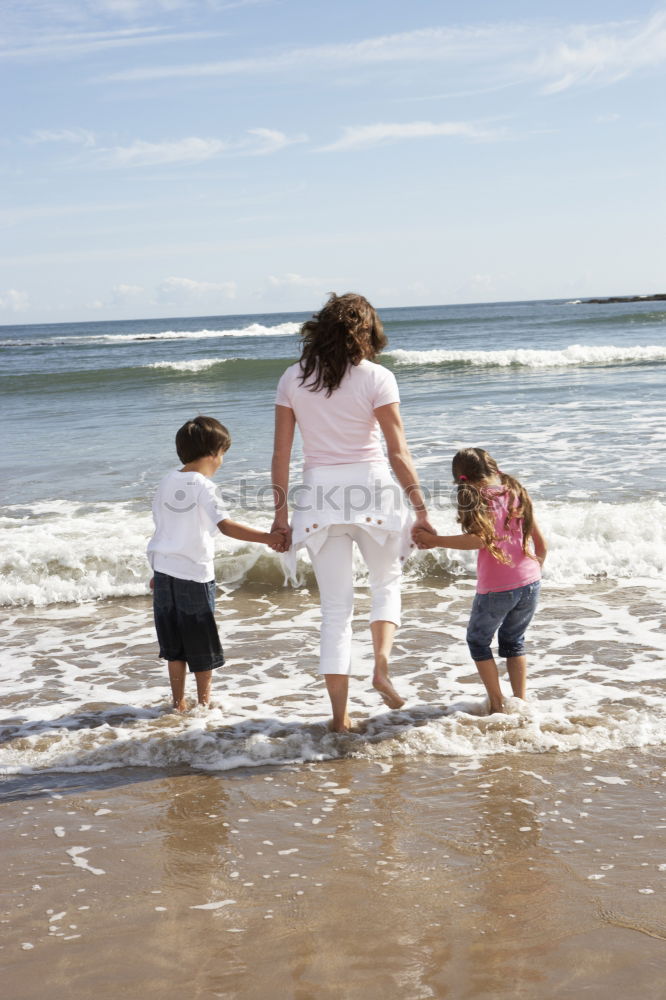 Similar – Image, Stock Photo Three happy children playing on the beach at the day time. Concept of summer vacation.