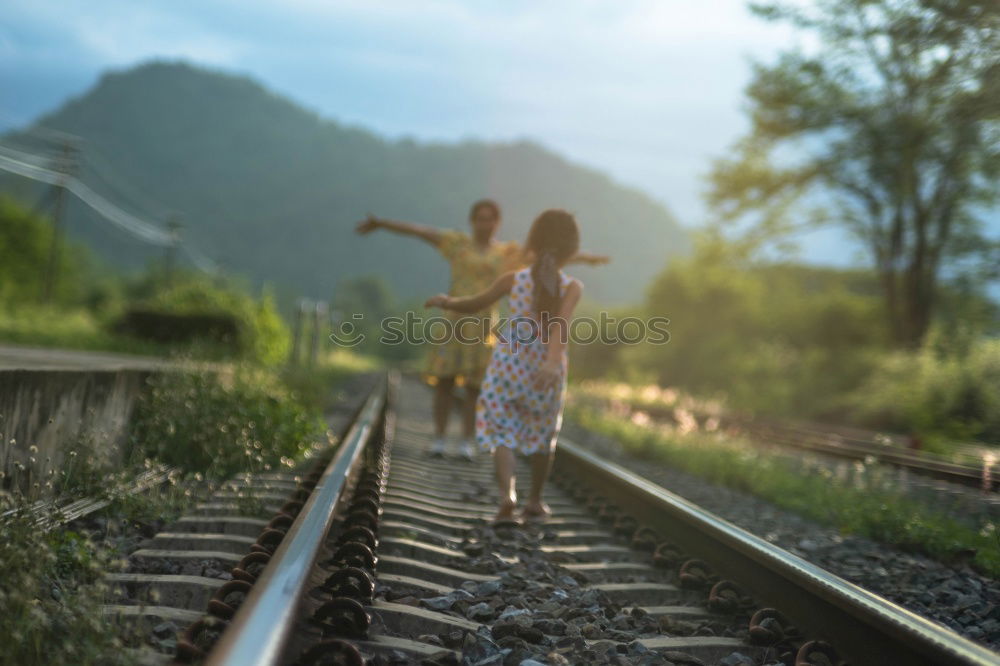 Similar – boy on the train tracks with suitcase