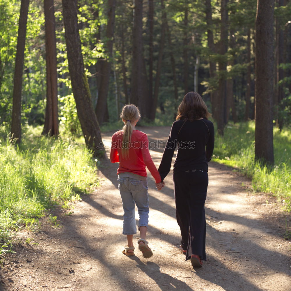 Similar – Retired couple walking their grandson on the path of a forest