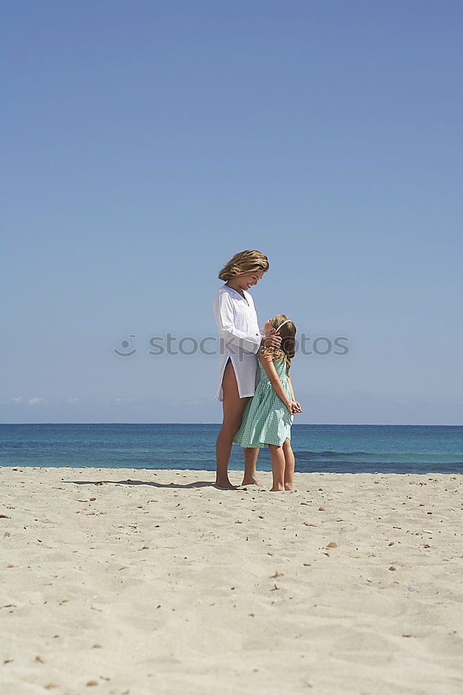 Similar – mother and sun having a walk at the beach