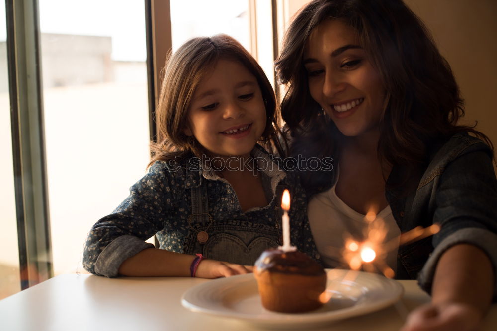 child girl playing checkers with her dad