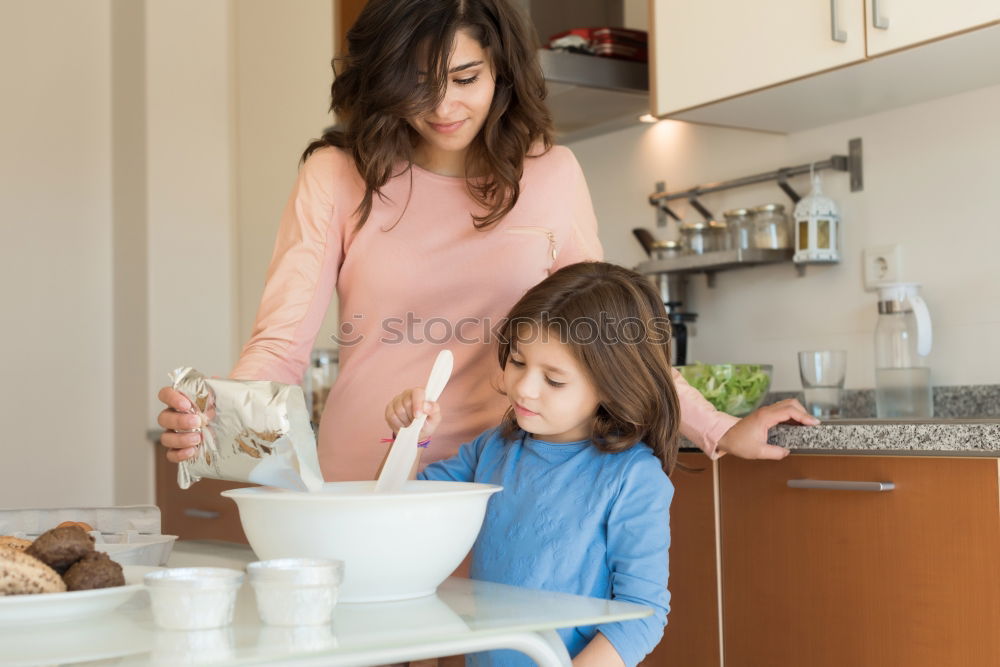 Similar – Mother and son baking together in kitchen