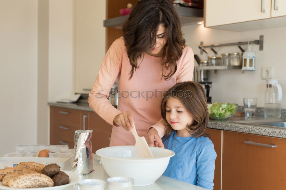 Similar – Mother and son baking together in kitchen