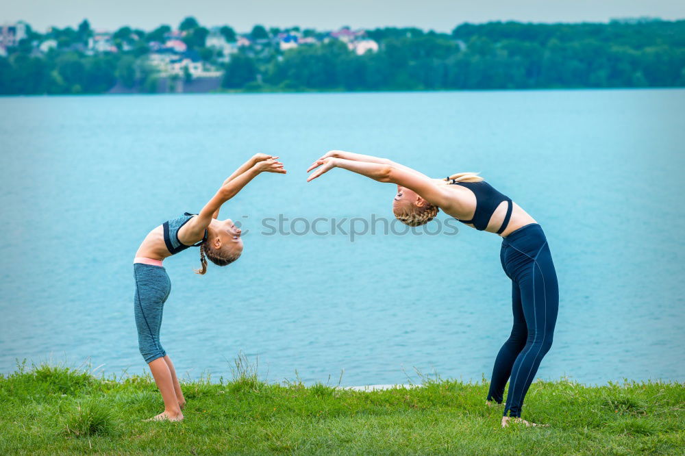 Similar – Image, Stock Photo Two young gymnast girls showing their flexibilty and stretching posing outdoor on a summer day