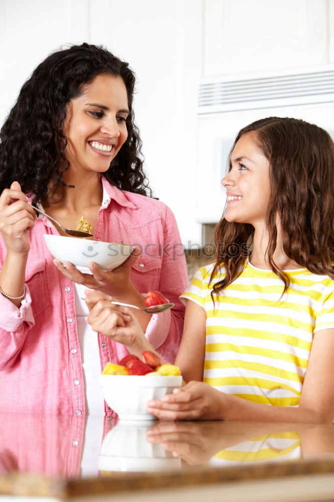 Similar – Image, Stock Photo Little girl cooking with her mother in the kitchen.