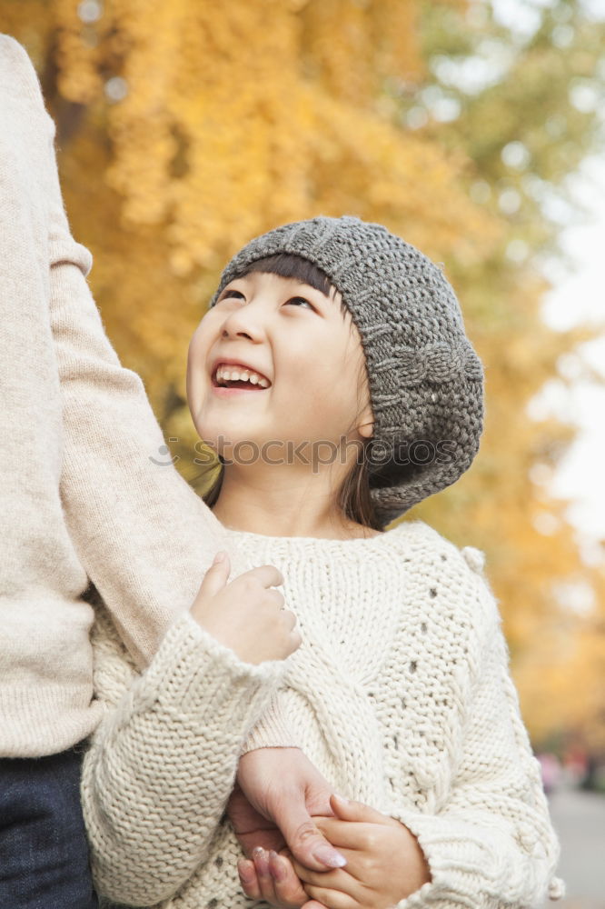 Similar – Young couple under blanket with hot drink kissing outdoors