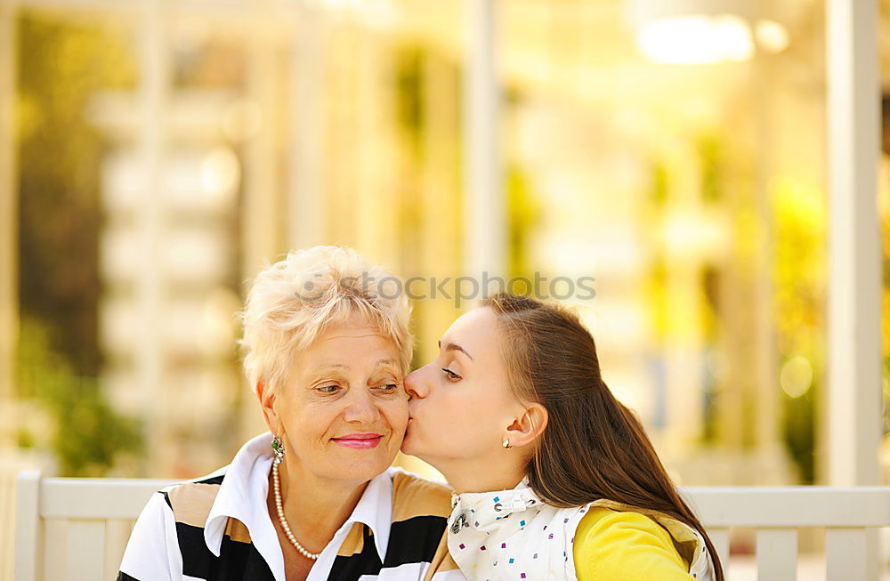 Similar – Two happy young women friends hugging in the street