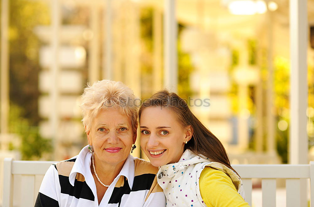 Similar – Two happy young women friends hugging in the street