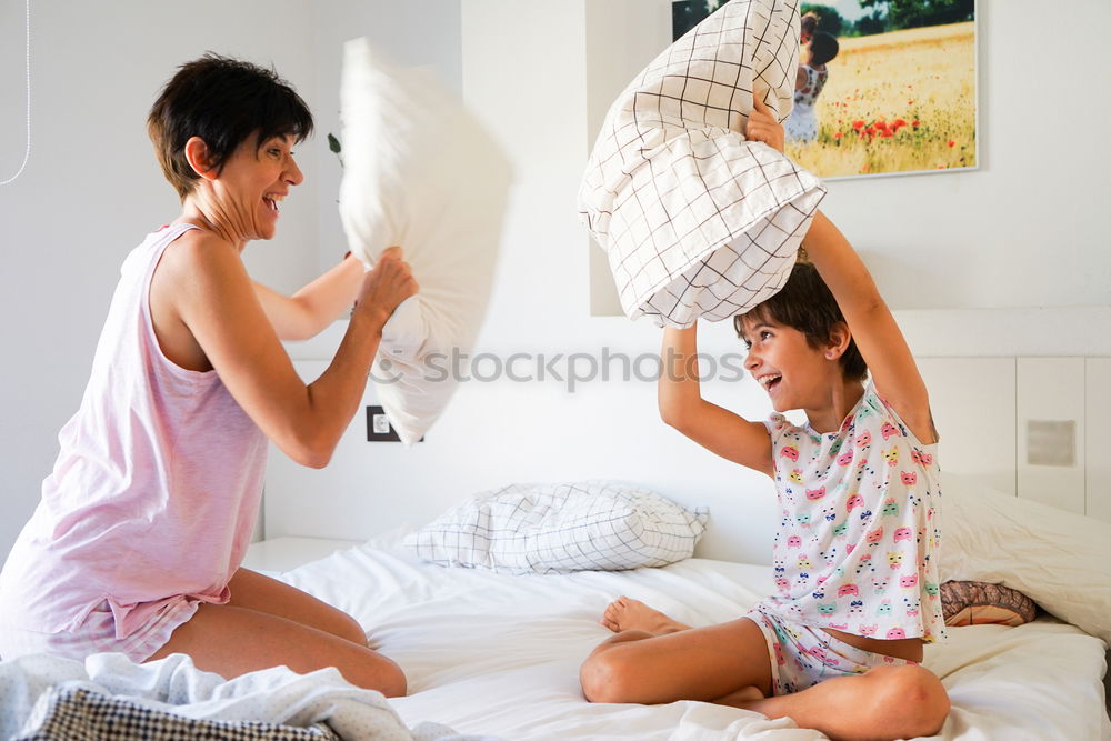 Similar – happy mother and child son playing pillow fight