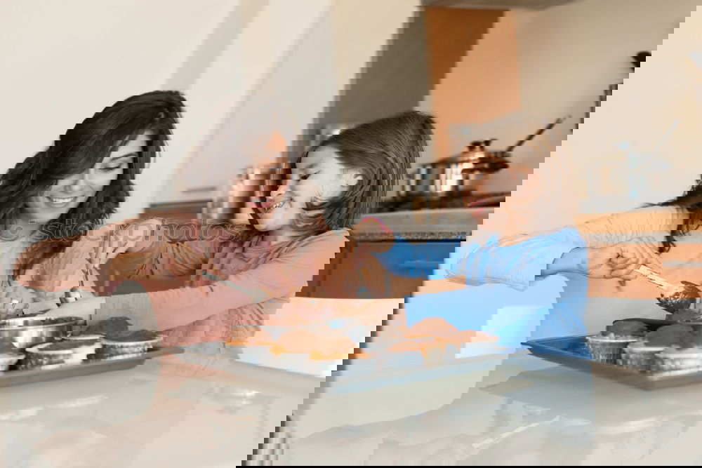 Similar – Image, Stock Photo Little girl cooking with her mother in the kitchen.