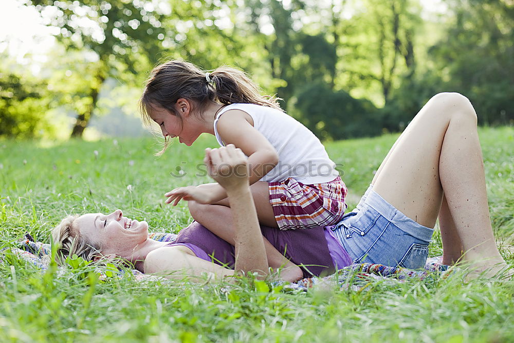 Similar – Image, Stock Photo Mother and daughter doing yoga exercises on grass in the park at the day time