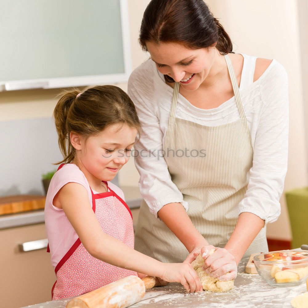 Similar – Little sisters girl preparing baking cookies.