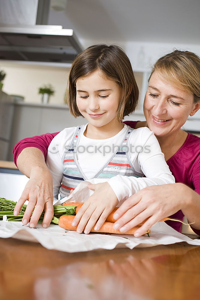 Similar – Woman feeding her little girl in kitchen