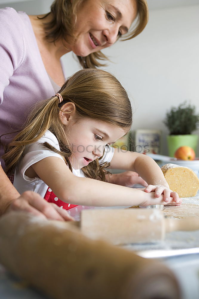 Similar – Little sisters girl preparing baking cookies.