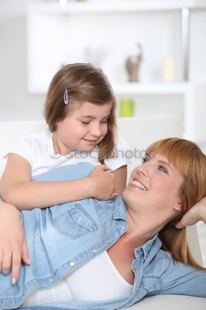 Similar – Image, Stock Photo Mother doing her little daughter’s hair. Family at home. Everyday life