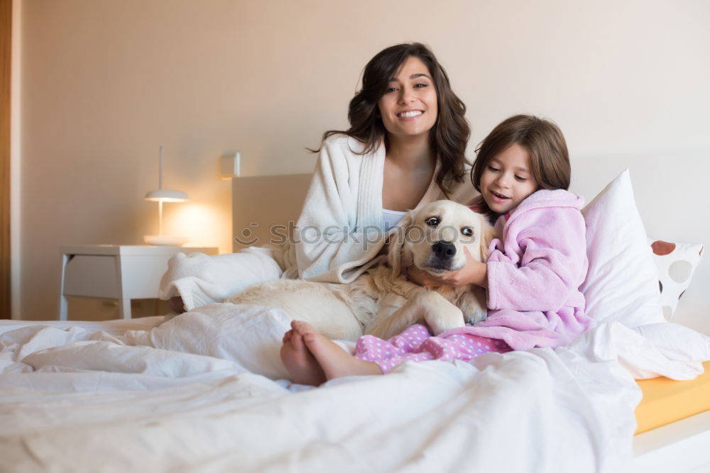 Similar – Couple relaxed at home in bed with their little daughter and the dog