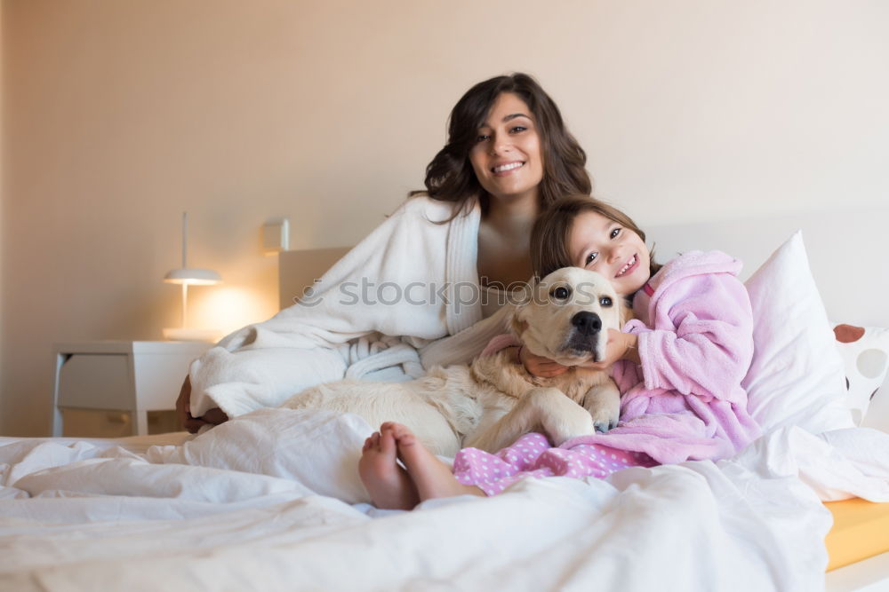 Similar – Couple relaxed at home in bed with their little daughter and the dog