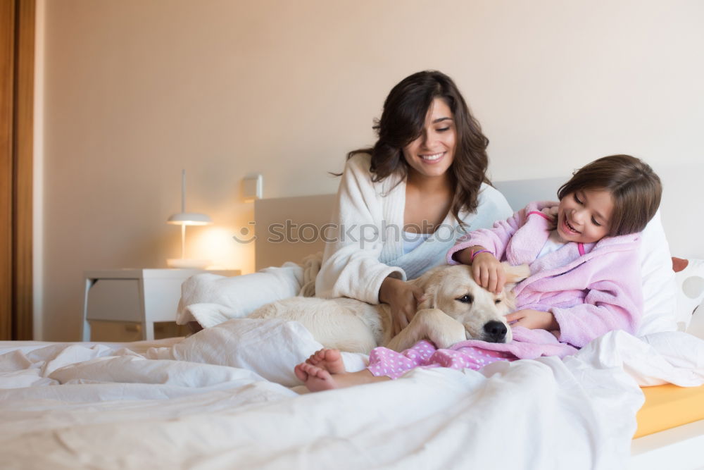 Similar – Couple relaxed at home in bed with their little daughter and the dog