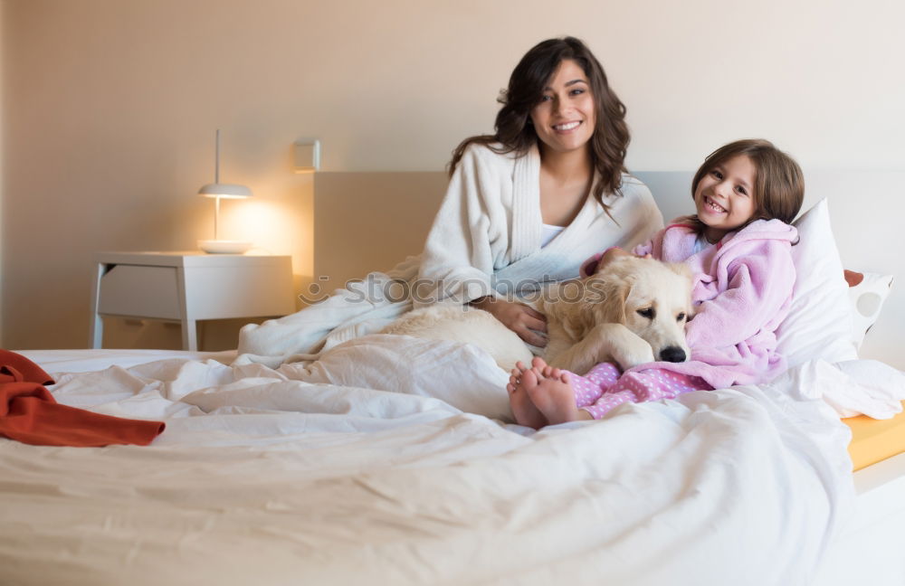 Similar – Couple relaxed at home in bed with their little daughter and the dog